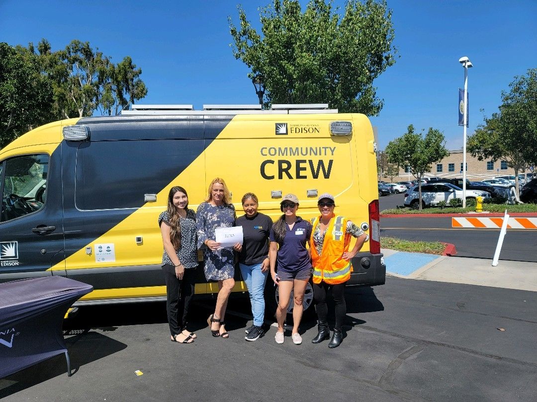 211 Staff standing in front of Yellow Southern California Edison Truck at Community Safety Fair