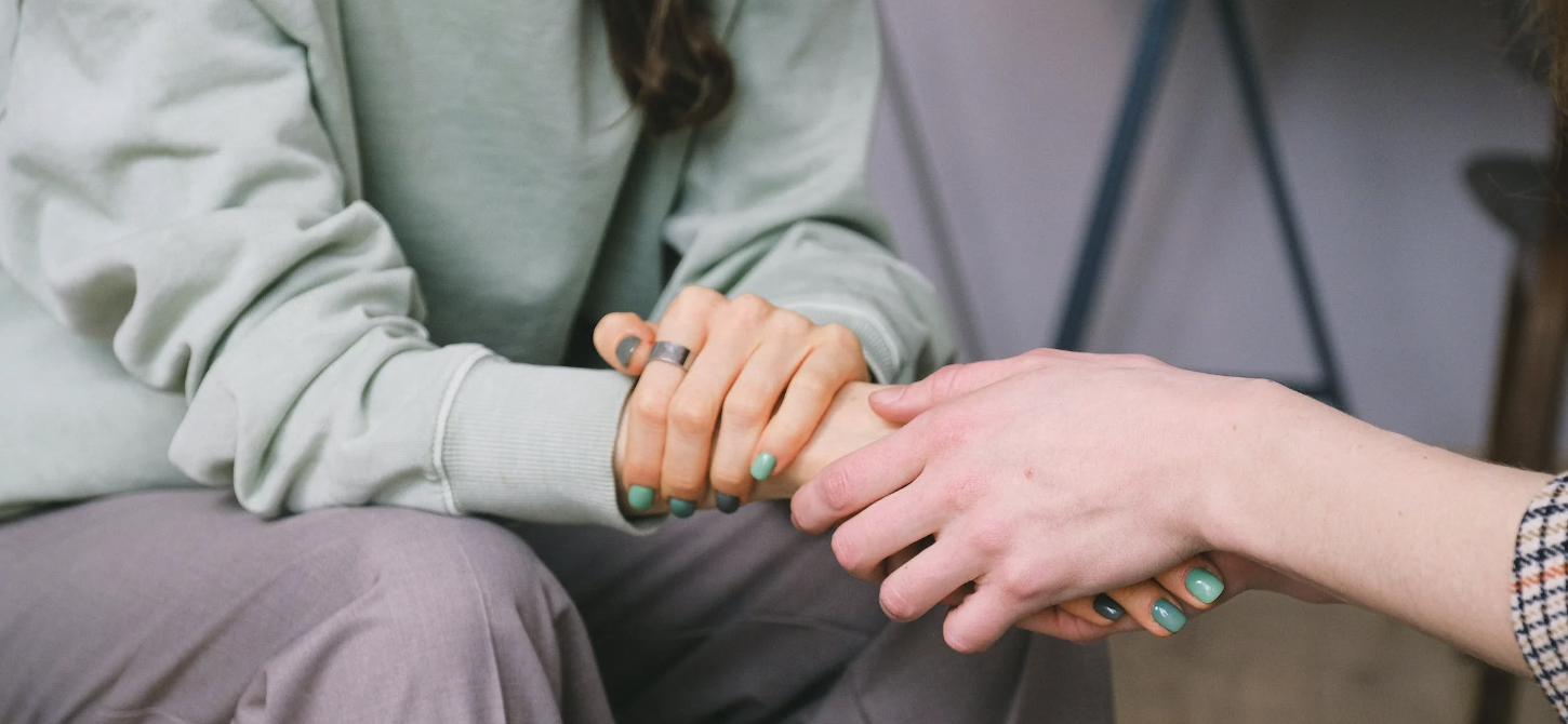 Caregiver holding patient hands