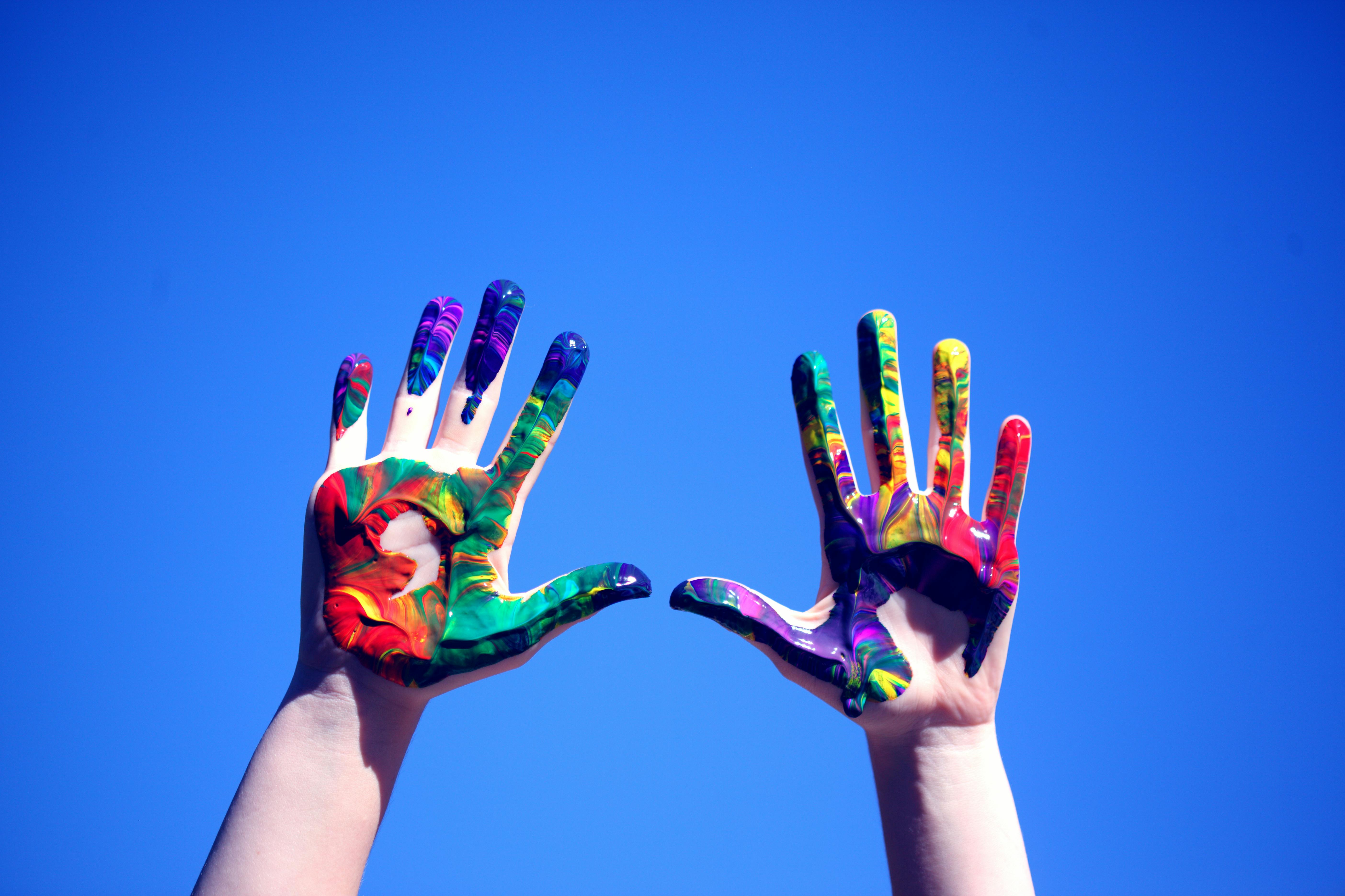 Hands Covered in Rainbow Paint