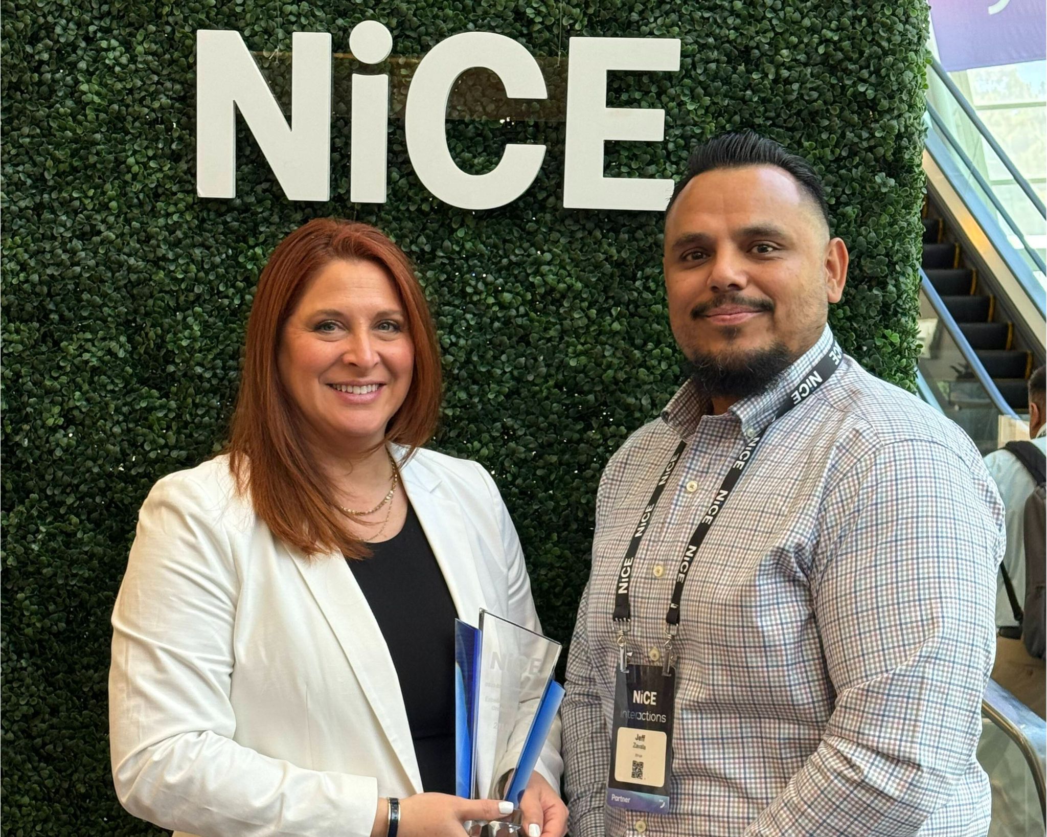Amy Latzer and Jeff Zavala accepting NiCE CX excellence award