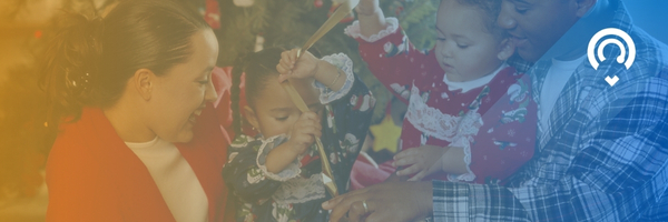 image of family together with two young daughters playing with ribbon