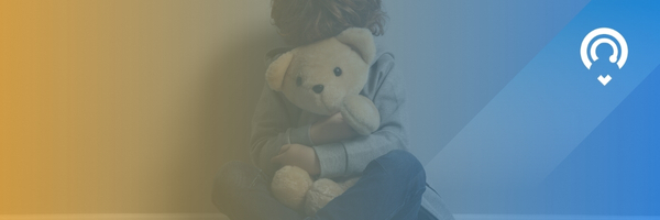 Child holding a teddy bear face is covered by the teddy bear, with a blue and yellow translucent color on the photo