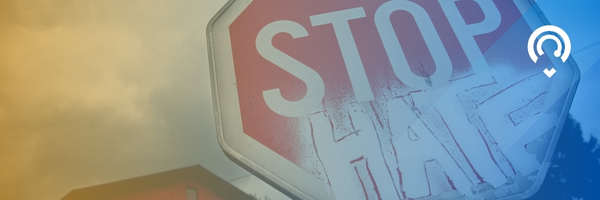 stop sign with the words hate under the word stop. indicating "Stop Hate" with a blue and yellow translucent color over the image 