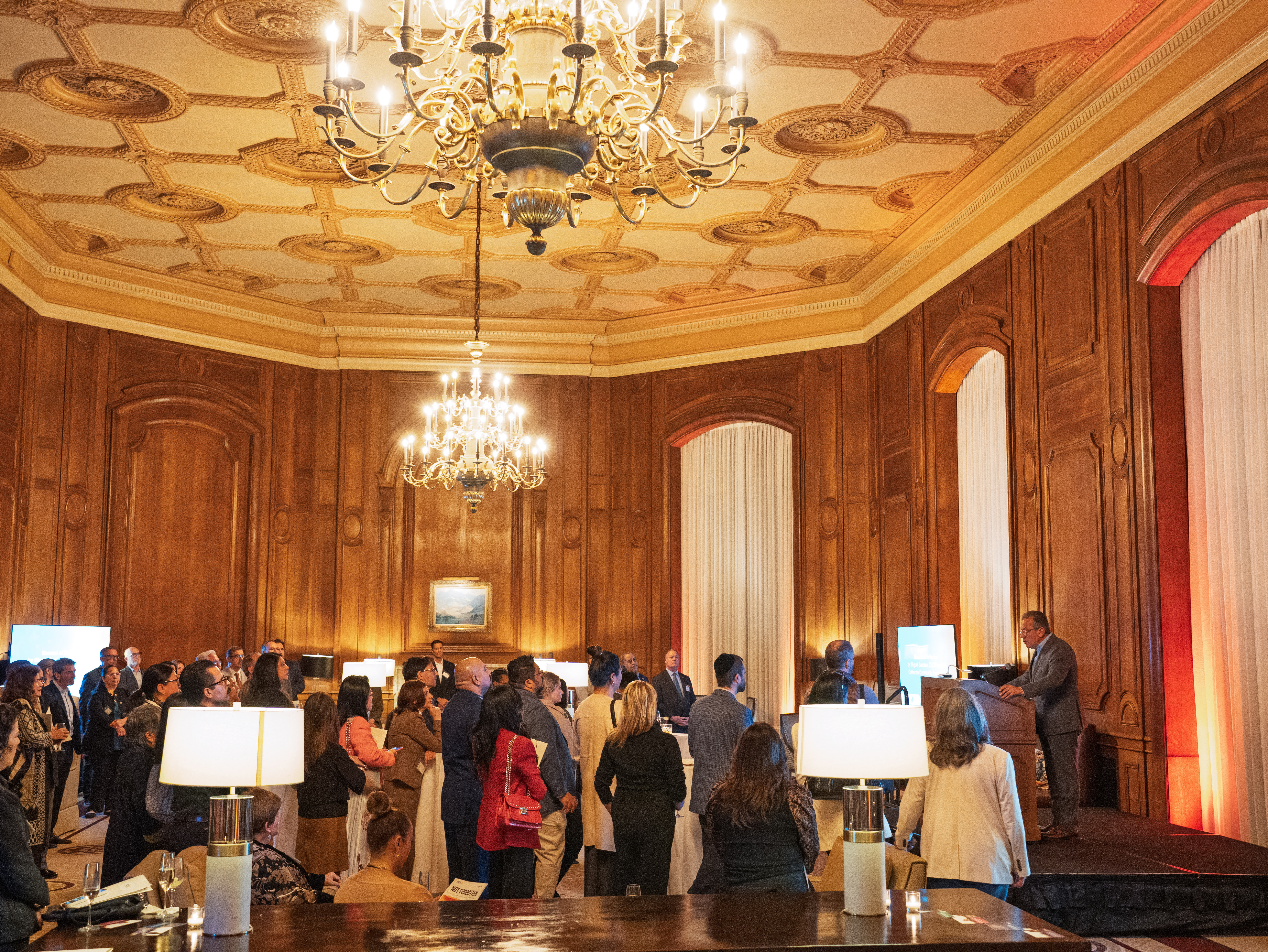 Expanded shot of the California Club with attendees listening to speaker