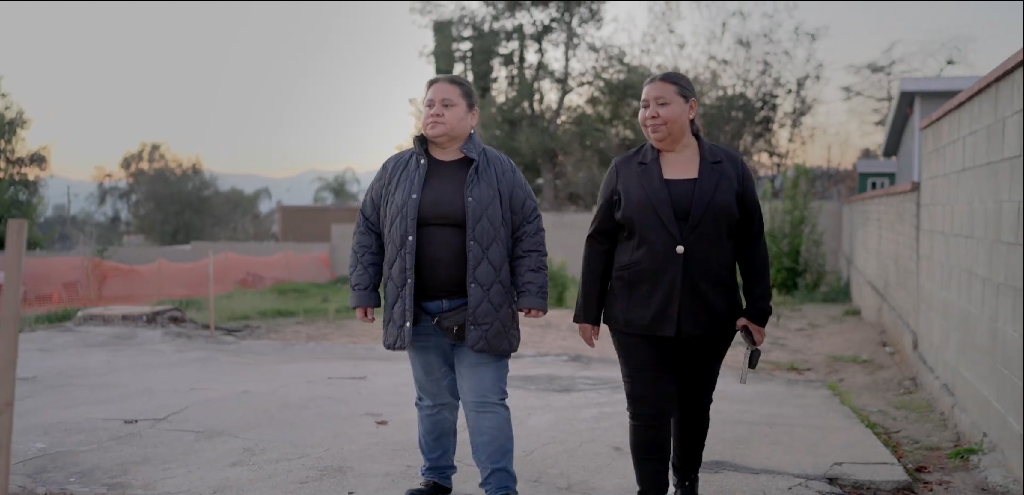 two people outside where there home was