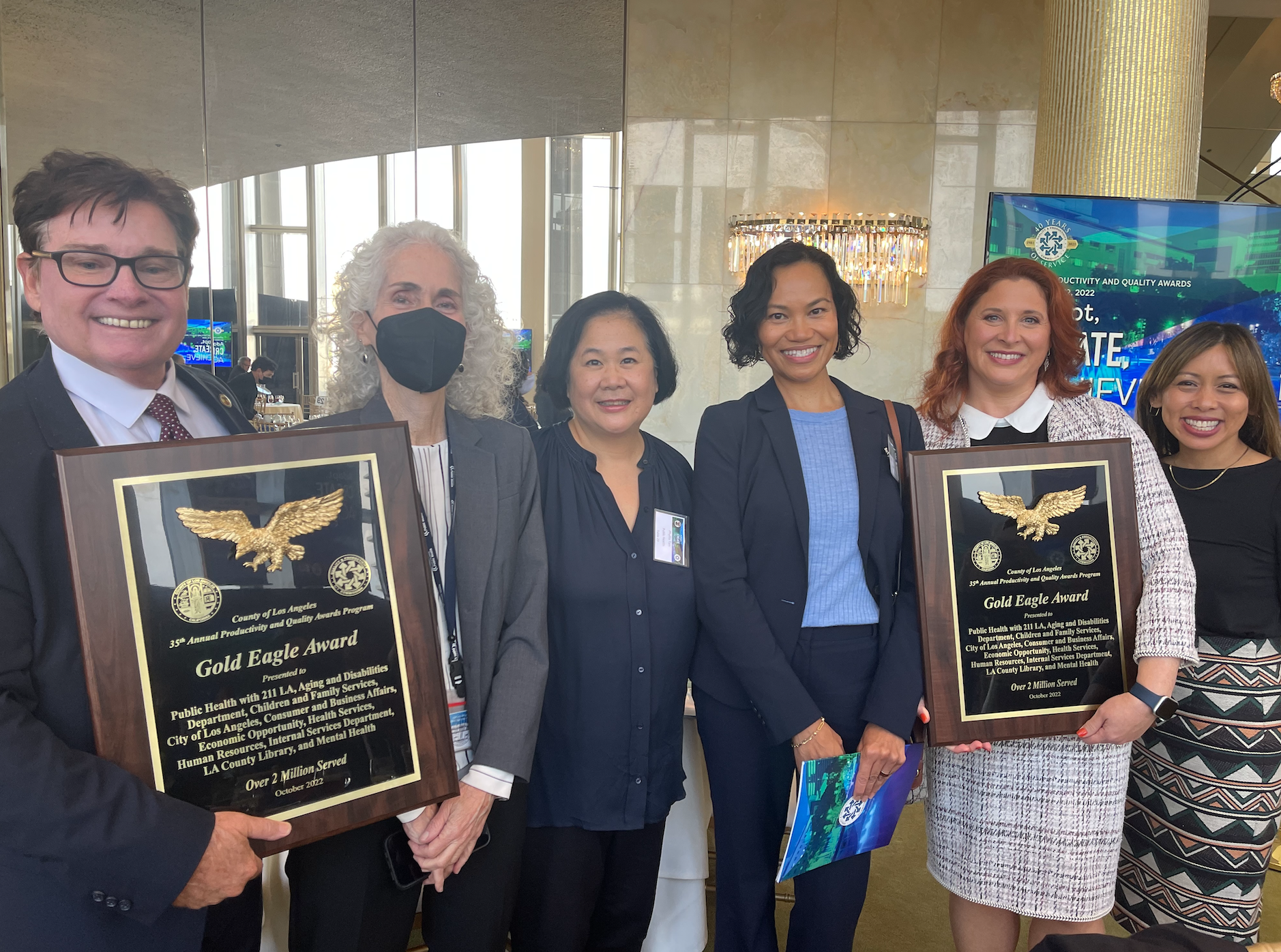  211 LA staff and Public Health Director Barbara Ferrer (2nd from left) hold the Gold Eagle awards received at the Productivity and Quality Awards ceremony. 