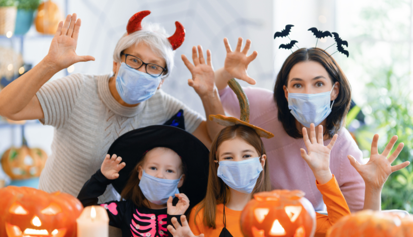 Family wearing a face masks with jack o lanterns
