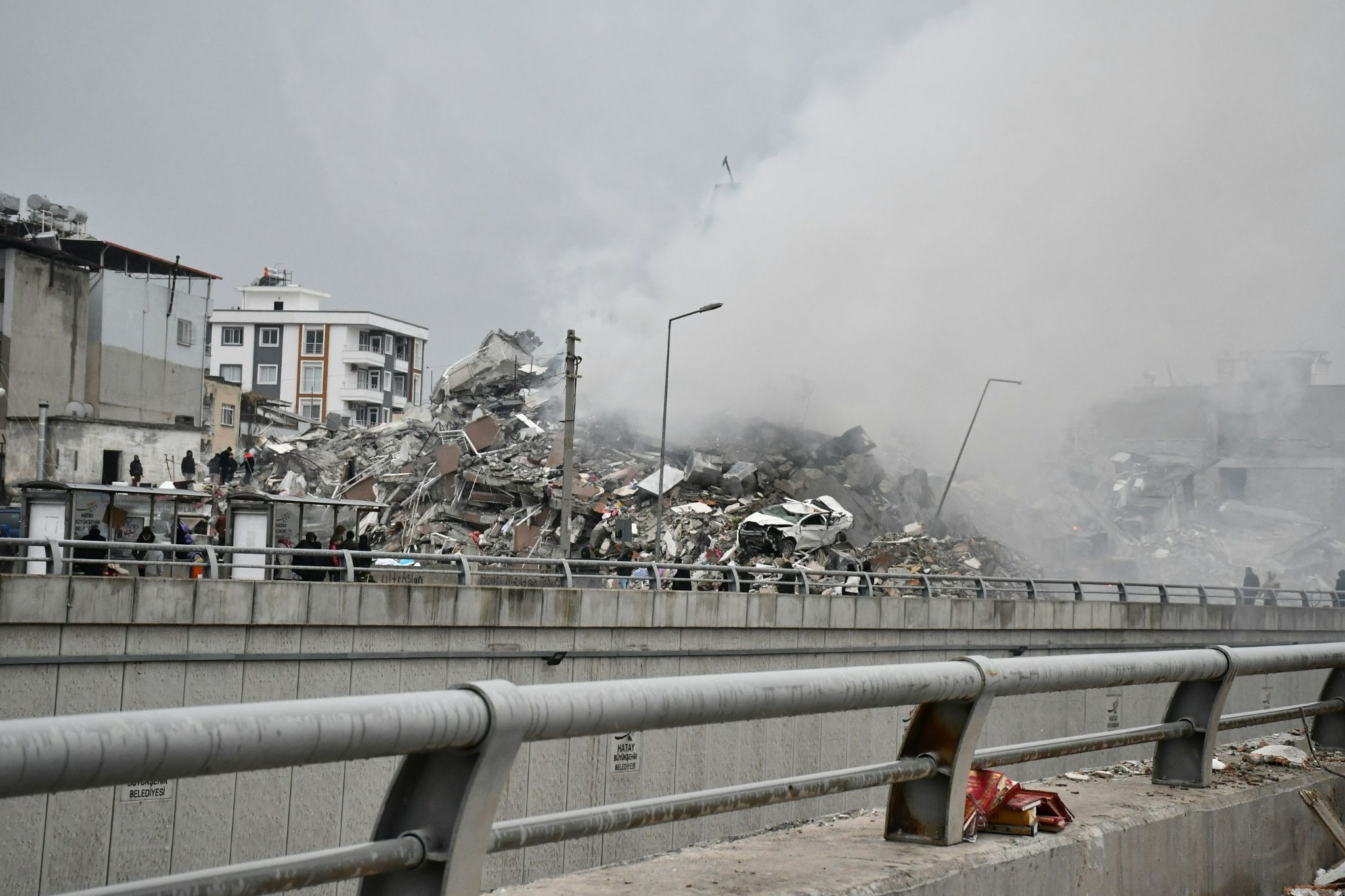 Houses destroyed after earthquake with smoke in the air