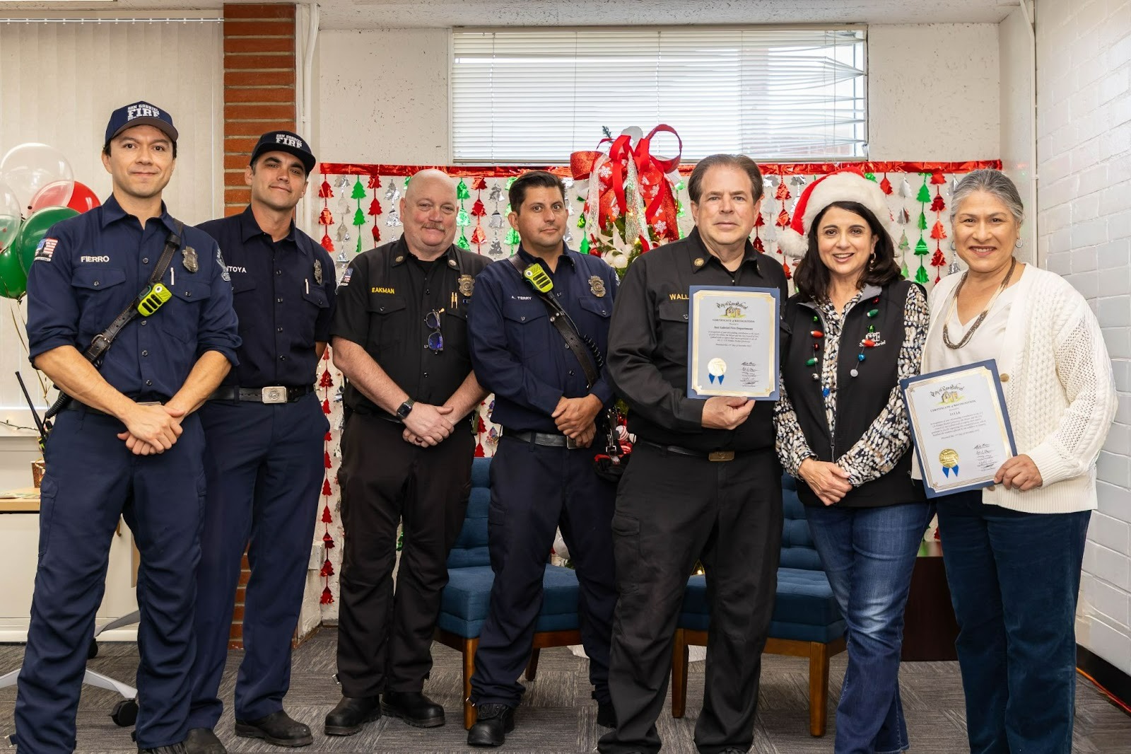 San Gabriel Mayor and 211 LA Board member Denise Menchaca, presenting certificate of recognition to San Gabriel fire department fire chief Steve Wallace and 211la executive director Maribel Marin. With four fireman posing in the picture