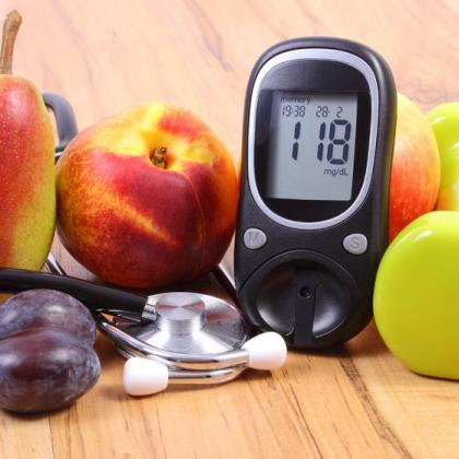Blood sugar monitor, fruit, and stethoscope