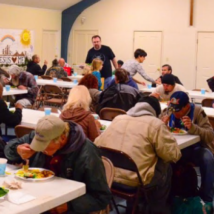 group of people eating at homeless shelter