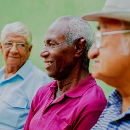 Three senior men sitting together looking happy