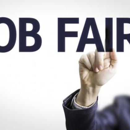blurred man in background writing job fair in foreground