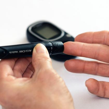 checking blood sugar with fingerstick and glucometer