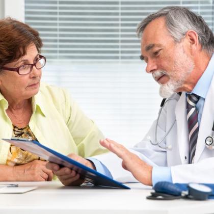 doctor explaining paperwork to woman client