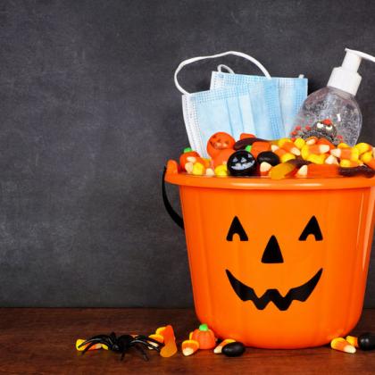 Halloween Jack-o-lantern Bucket with candy corn, face masks, and hand sanitizer