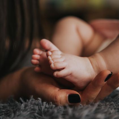 Mothers hands and baby feet