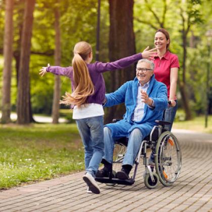 Man in Wheel Chair and Caregiver 