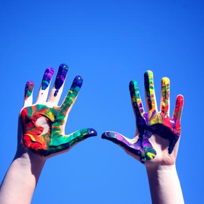 Hands Covered in Rainbow Paint