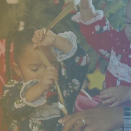 image of family together with two young daughters playing with ribbon