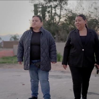 two people outside where there home was