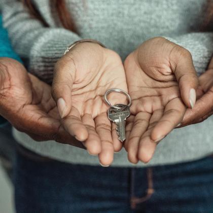 child and parent holding key 