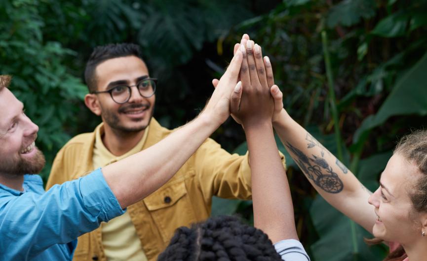 Friends cheering with hands in air