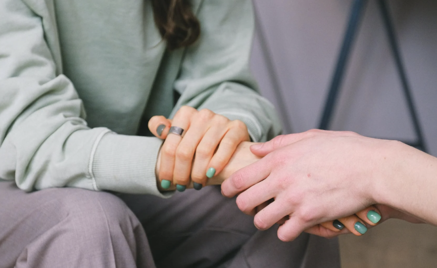 Caregiver holding patient hands