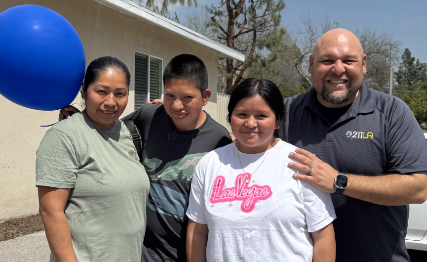 211 LA Care Coordinator smiling with Family Clients