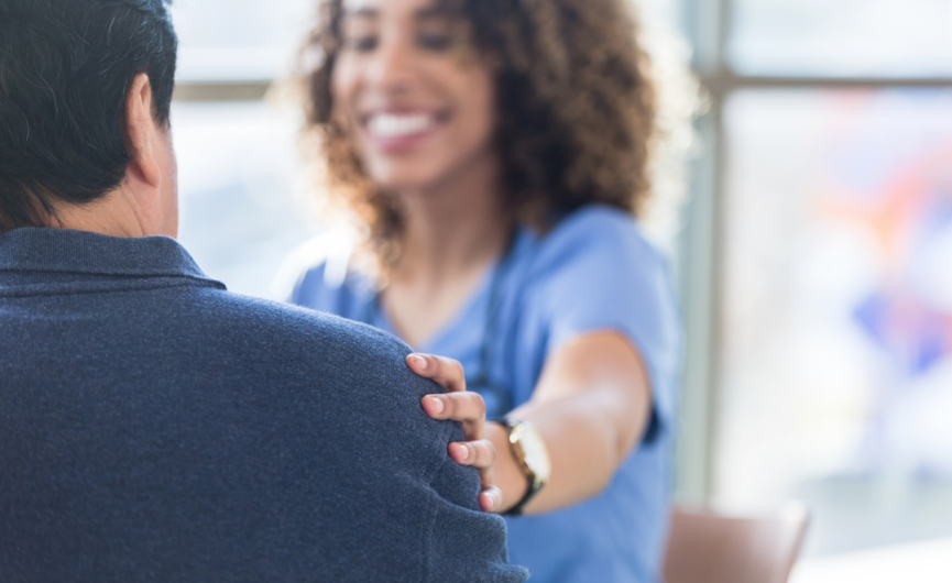 nurse with patient with hand on shoulder