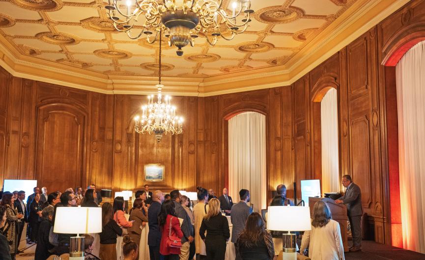 Expanded shot of the California Club with attendees listening to speaker