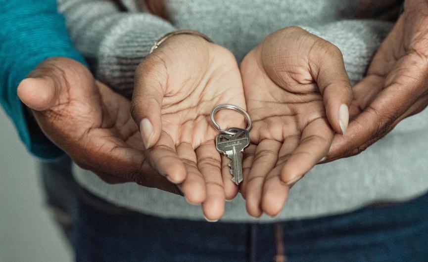 child and parent holding key 