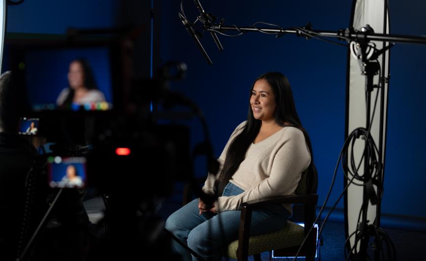 Yessica Quiroz, Wildfire survivor, in frame with camera equipment pointing to her direction