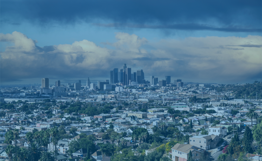 Skyline of los angeles with neighborhoods surrounding it, a blue half transparent image overlays the image