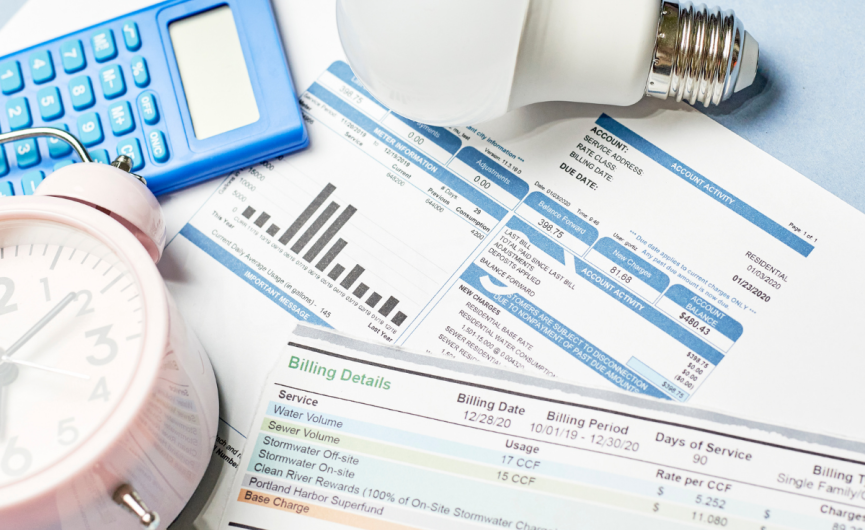 Images shown in frame, are a light buld, calculcator, clock. It also includes utility bills.