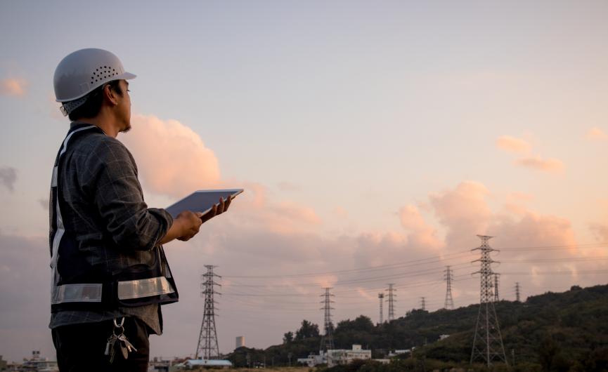 Person holding a clipboard looking out to the distance, 
