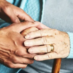 Caregiver holding patient hands