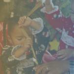 image of family together with two young daughters playing with ribbon