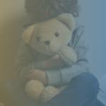 Child holding a teddy bear face is covered by the teddy bear, with a blue and yellow translucent color on the photo