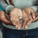 child and parent holding key 