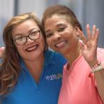 Care Coordinator left hand side, Yvonne wearing glasses and blue 211 LA shirt, Robin Ivory on the right, smiling and waving wearing a pink shirt