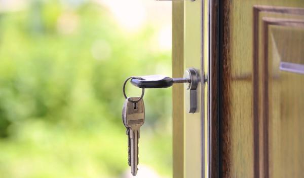 Keys in open door representing housing